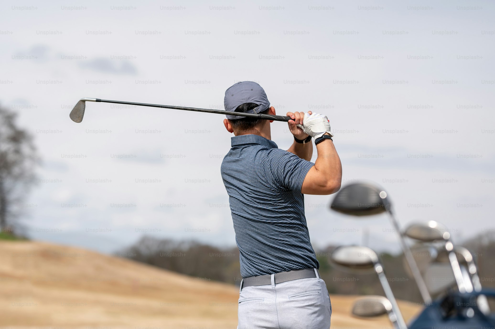 Golfer mid-swing representing active, pain-free lifestyle after spine treatment